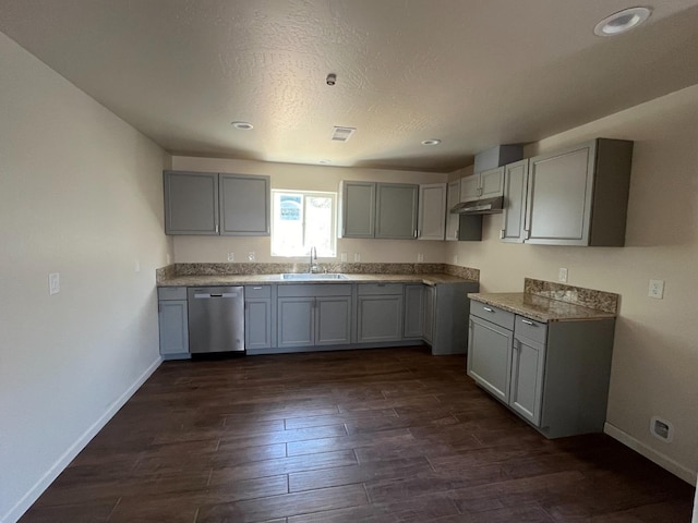 kitchen featuring sink, stainless steel dishwasher, dark hardwood / wood-style floors, and gray cabinetry