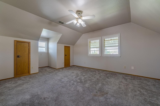 bonus room with lofted ceiling, carpet, and ceiling fan