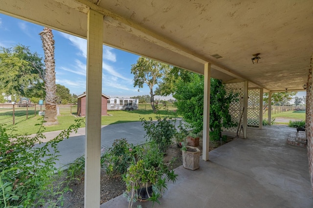 view of patio with a storage shed