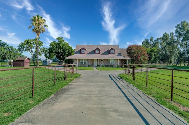 view of front facade featuring a front lawn and a rural view