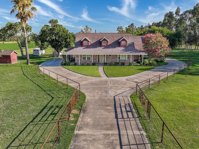 view of front of property featuring a front yard and a storage unit