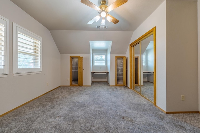 additional living space with ceiling fan, carpet flooring, and vaulted ceiling