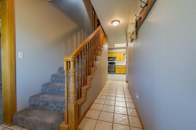 stairway featuring tile patterned flooring