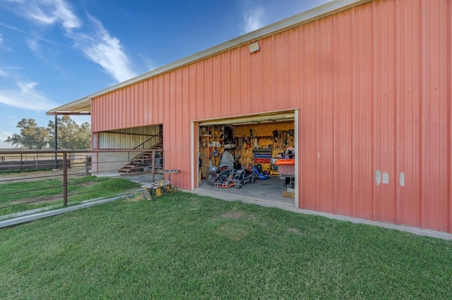 view of outbuilding featuring a lawn