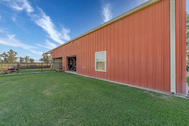 view of side of home with a yard and an outbuilding