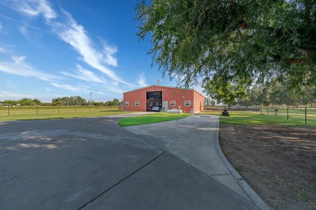 exterior space featuring an outdoor structure and a front lawn