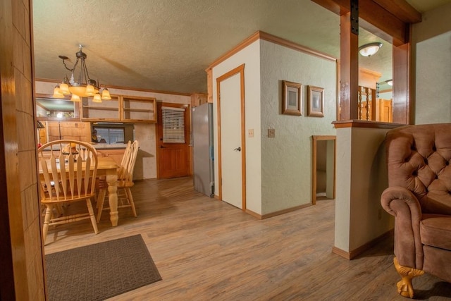 dining area with hardwood / wood-style flooring, crown molding, and a textured ceiling