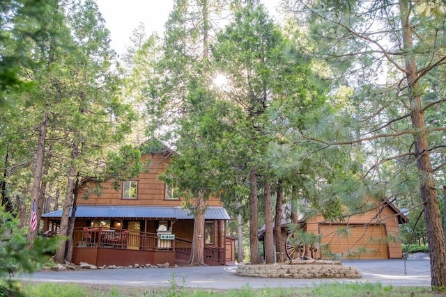 log cabin with a garage and covered porch