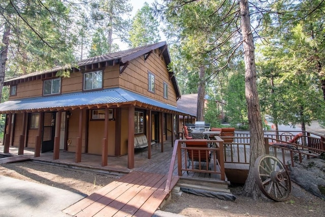 back of property with a wooden deck