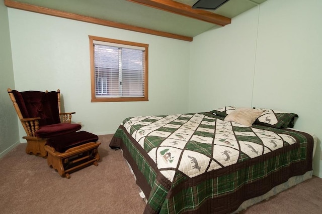 carpeted bedroom with beam ceiling