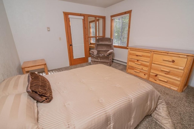 carpeted bedroom with a baseboard heating unit