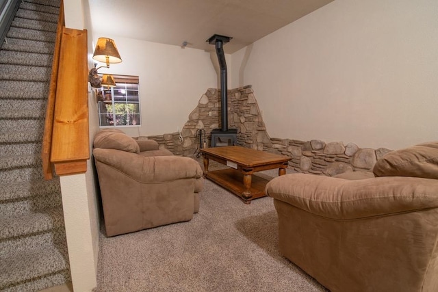 living room featuring carpet flooring and a wood stove