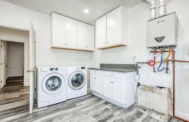 12647 E Clarkson Ave, Kingsburg, CA 93631 - laundry area with water heater, separate washer and dryer, light hardwood / wood-style floors, and cabinets