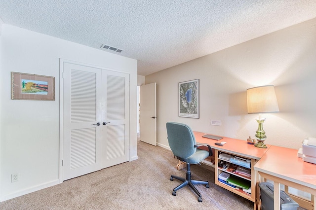 office with light carpet and a textured ceiling