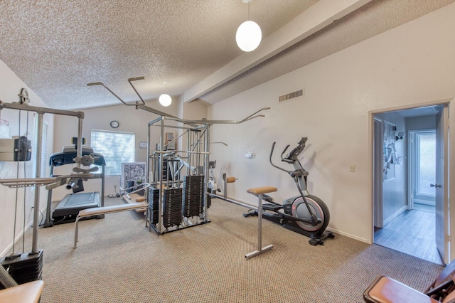 exercise area with carpet floors, plenty of natural light, a textured ceiling, and vaulted ceiling