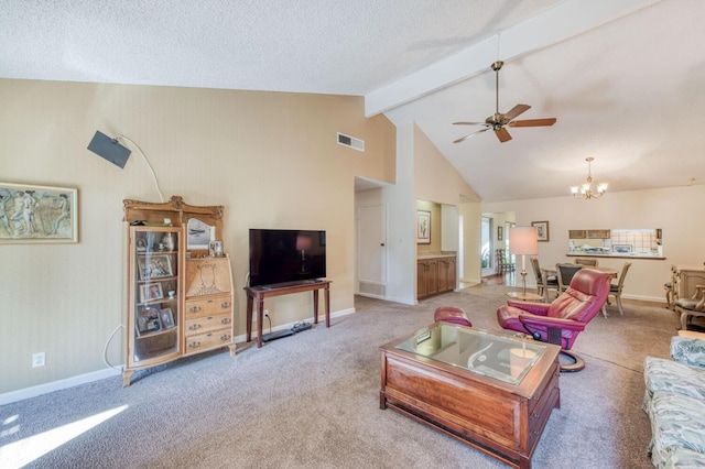 carpeted living room with high vaulted ceiling, beamed ceiling, and ceiling fan with notable chandelier