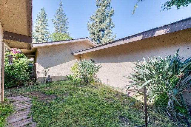 view of home's exterior with a lawn