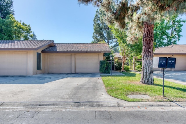 view of front of home with a garage and a front lawn