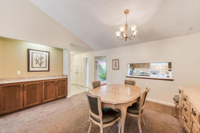 carpeted dining area featuring an inviting chandelier, a textured ceiling, and vaulted ceiling