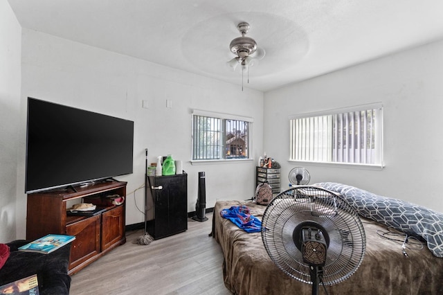 bedroom with light hardwood / wood-style flooring and ceiling fan