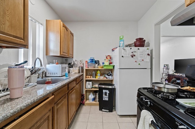 kitchen featuring light stone counters, sink, white appliances, light tile patterned floors, and extractor fan