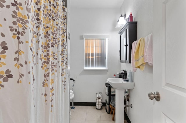 bathroom featuring a shower with shower curtain, tile patterned floors, and toilet