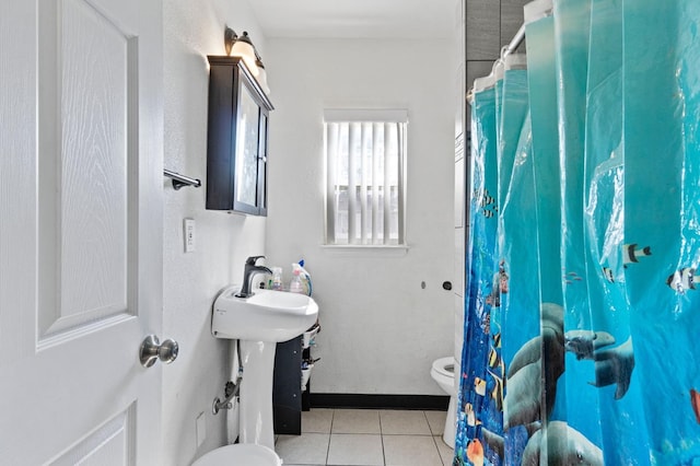 bathroom featuring walk in shower, tile patterned floors, and toilet