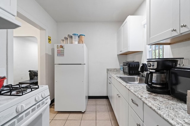 kitchen with light tile patterned flooring, sink, white cabinets, white appliances, and exhaust hood