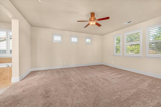 empty room with ceiling fan and carpet flooring