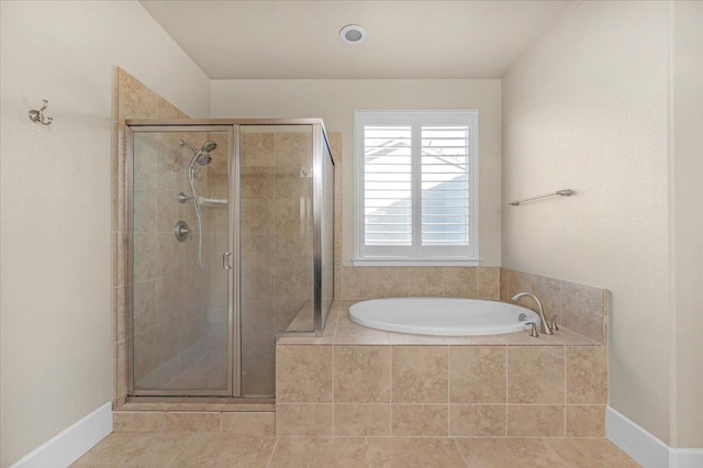 bathroom with independent shower and bath and tile patterned flooring