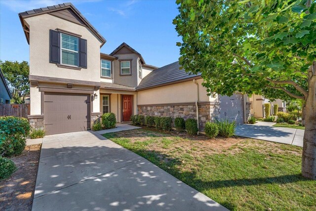 view of front of property with a garage and a front yard