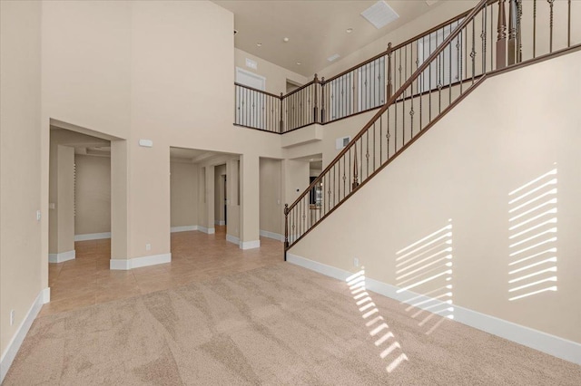 interior space featuring carpet floors and a high ceiling