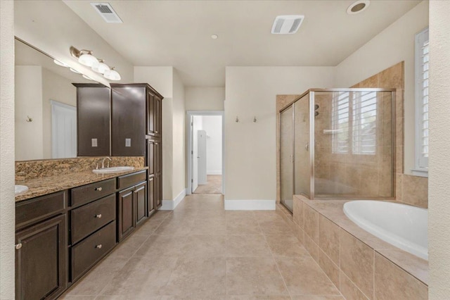 bathroom with plus walk in shower, tile patterned flooring, and dual bowl vanity