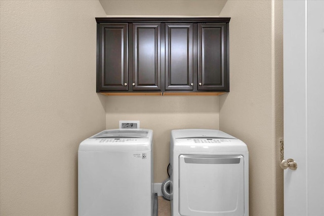 laundry area featuring cabinets and washing machine and dryer