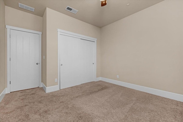 unfurnished bedroom featuring a closet, carpet, and ceiling fan