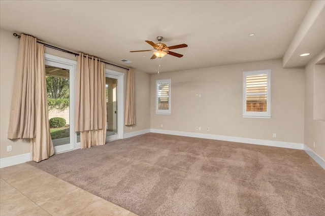 spare room featuring light tile patterned floors and ceiling fan