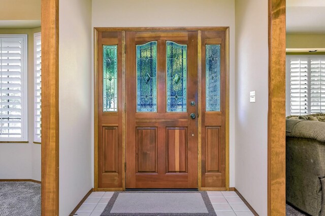 entryway with light tile patterned floors