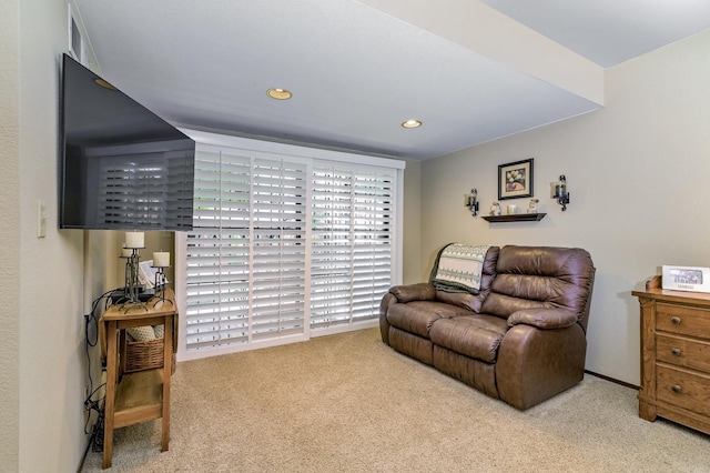 sitting room featuring light colored carpet