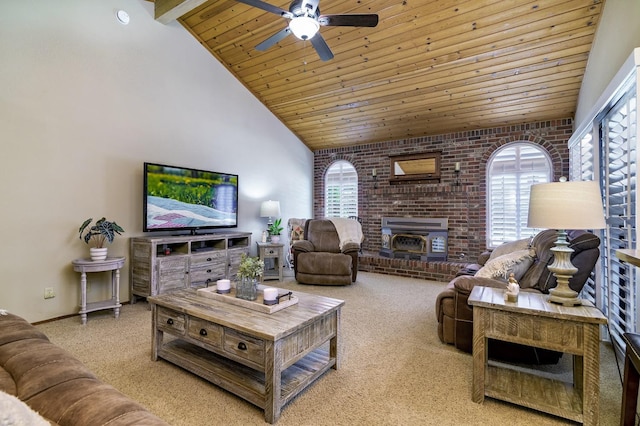 living room with a healthy amount of sunlight, ceiling fan, light colored carpet, and beamed ceiling