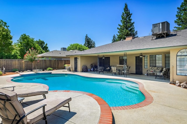 view of pool with ceiling fan, central AC unit, a patio area, and a diving board