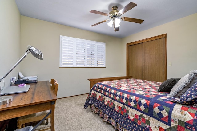 bedroom featuring light colored carpet, ceiling fan, and a closet