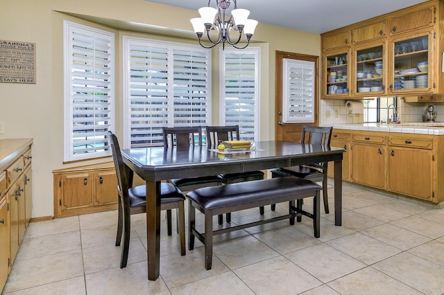 tiled dining area with a notable chandelier