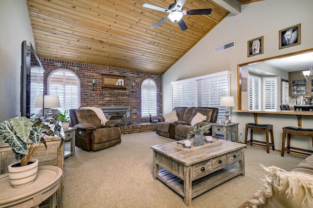 carpeted living room with wood ceiling, ceiling fan, a fireplace, and a wealth of natural light