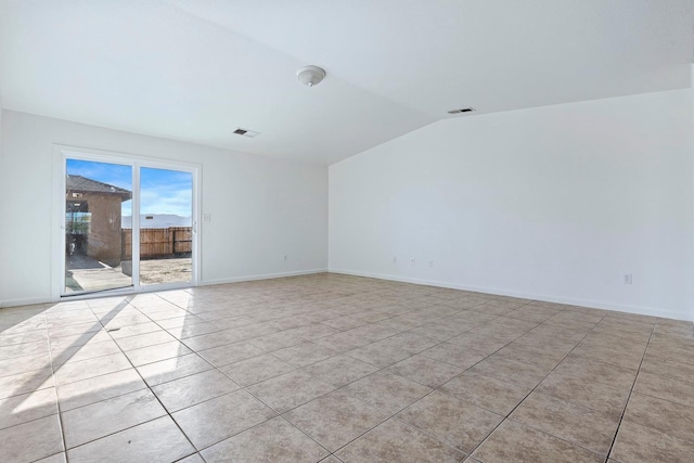 tiled spare room with lofted ceiling