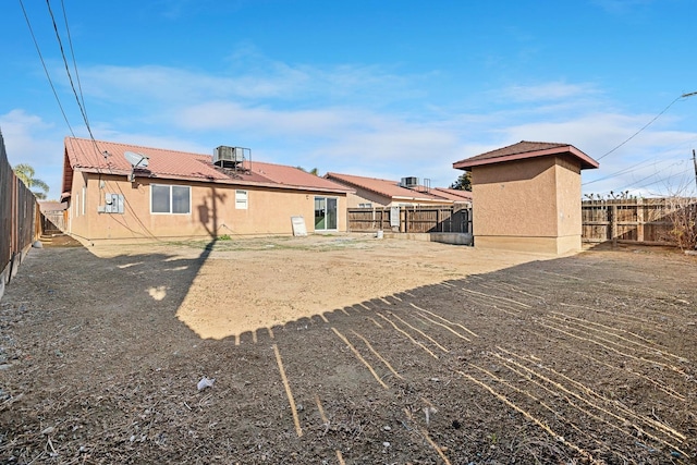 rear view of house with central air condition unit