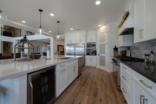 kitchen with premium appliances, custom range hood, light wood-type flooring, wine cooler, and backsplash