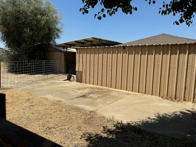 view of gate featuring a patio area and fence