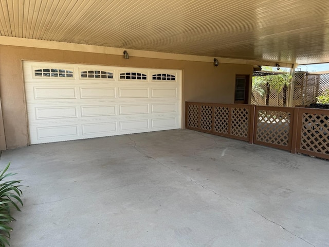 garage featuring concrete driveway