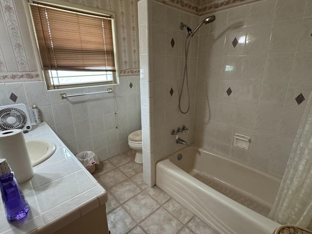 bathroom featuring shower / bath combo with shower curtain, toilet, tile walls, wainscoting, and vanity