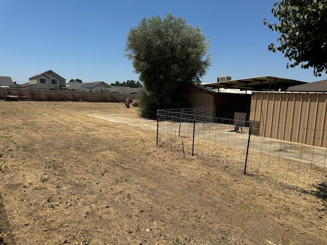 view of yard with an outbuilding and fence